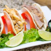 Tacos De La Calle · Street tacos on 4.5 Inch Corn or Flour tortilla filled with your choice of filling, topped w...