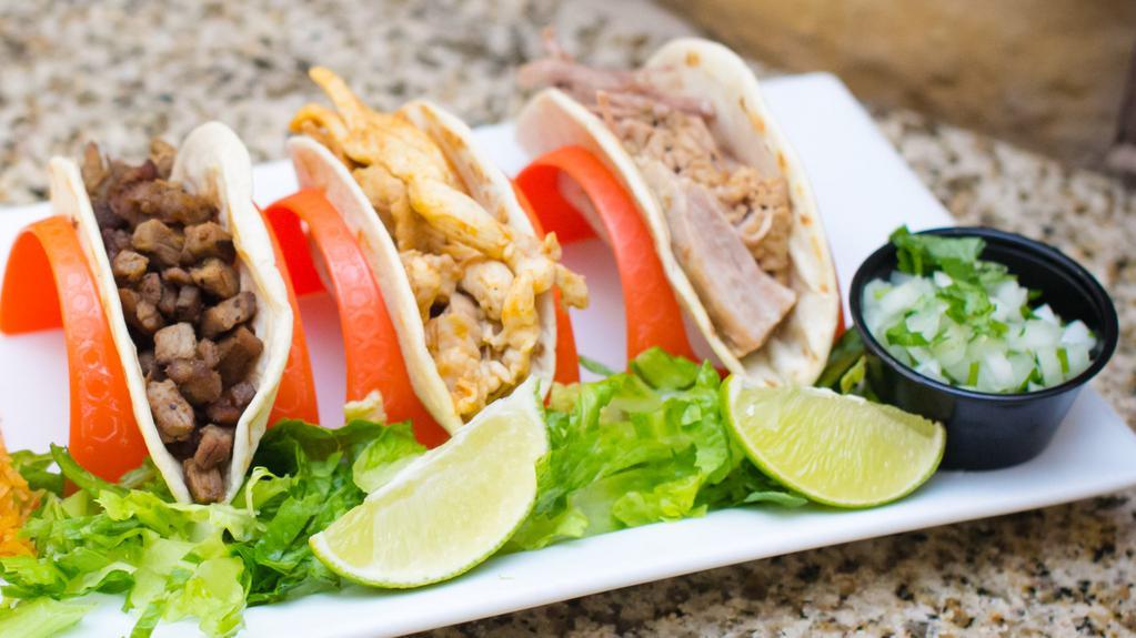 Tacos De La Calle · Street tacos on 4.5 Inch Corn or Flour tortilla filled with your choice of filling, topped with lettuce, chopped onion and cilantro.