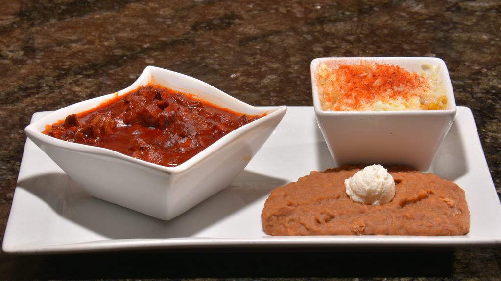 Chile Colorado · Grilled chopped steak, Pork or chicken blended with red salsa and served with four Flour or Corn tortillas. Choice of Two sides.