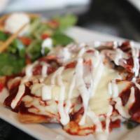 Chilaquiles · Fried tortilla strips simmered in a red or green salsa with shredded cheese and chicken brea...