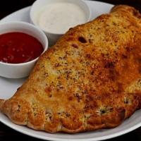 Quattro Formaggi Calzone · Our tomato sauce, roasted garlic, house cheese blend, with a touch of asiago, and shaved par...