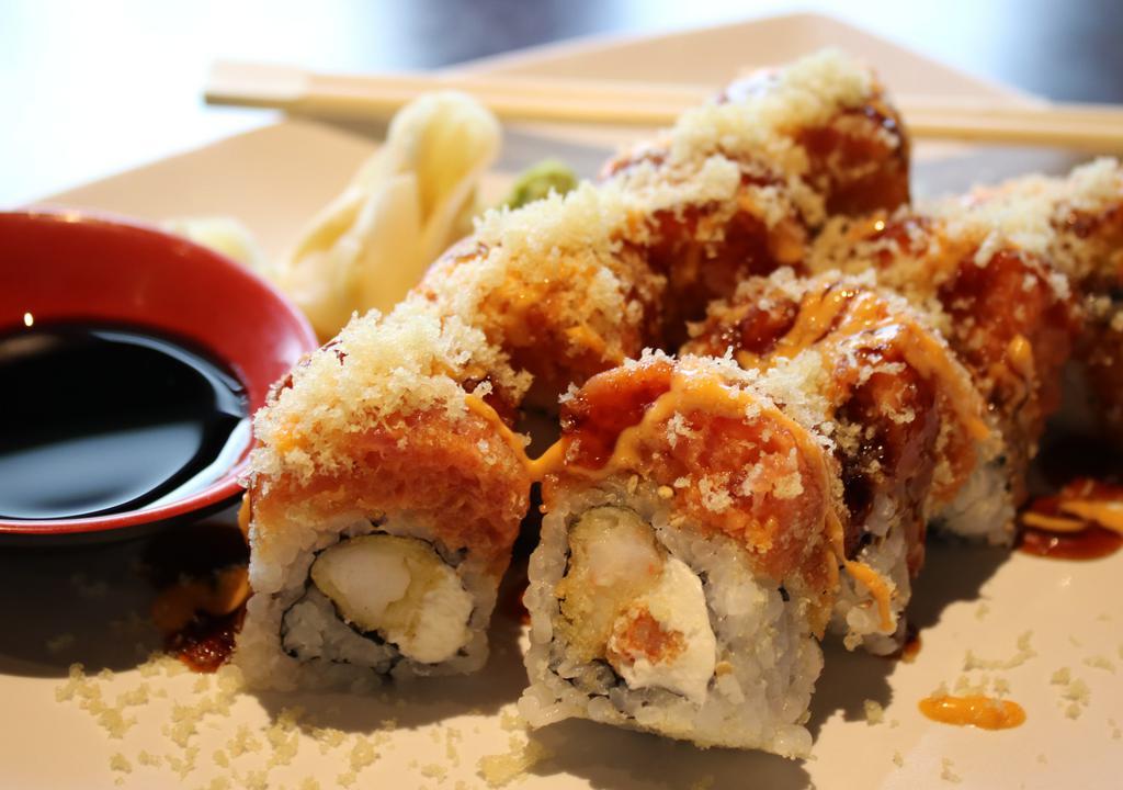 Dynamite Roll · Shrimp tempura,cream cheese inside, topped with spicy tuna and tempura bits,drizzled with eel and spicy mayo sauce