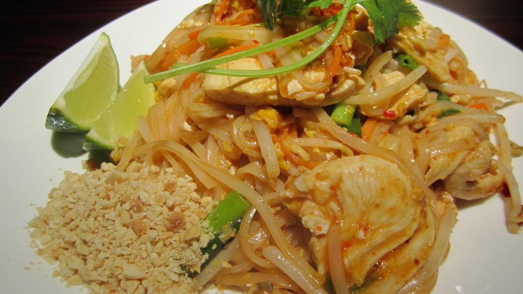 Pad Thai · Rice noodles stir-fried with egg, onion,bean sprout,carrots,red bell pepper served with crushed peanuts and lime wedge on the side