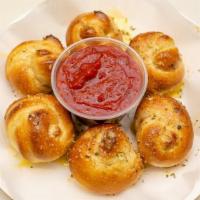Garlic Knots · A classic snack our garlic knots are strips of pizza dough tied in a knot baked and then top...