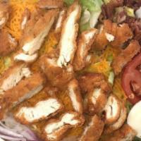 Chicken Strips Salad · Crispy chicken strips over lettuce with bacon, cheddar cheese, tomatoes, onions, and hard-bo...