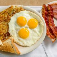 The Hungry Man Breakfast · Three eggs any style, two bacon strips, two sausage links, and a slice of ham, homemade hash...