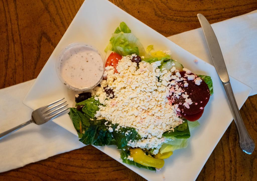 Greek Salad · Lettuce, tomatoes, onions, beets, black olives, pepperoncini, pita & feta cheese.