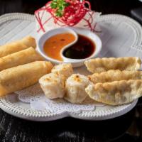 Appetizer Land Platter · Sampling platter of gyoza, mini eggroll and shumai.