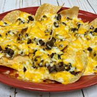 Chicken Or Beef Nachos · Chips topped with chicken or beef and melted cheese.