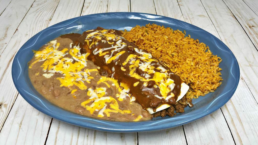 Burrito Lunch · Big flour tortilla with beef or chicken, with your preferred sauce and cheese on top. Served with two sides. Add guacamole and sour cream for an extra charge.