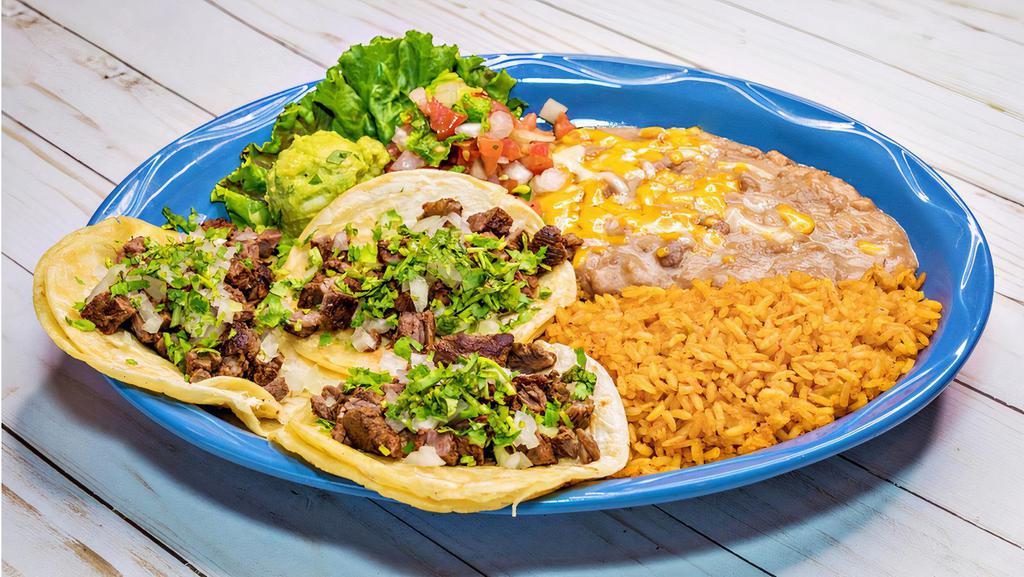 Mexican Tacos · Three soft corn tortilla tacos filled with beef, chicken or pastor fajita with onions, cilantro, pico de gallo and guacamole. Served with two sides.