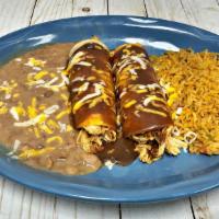 Enchiladas De Mole · Two chicken or beef enchiladas with mole sauce and cheese on top. Served with two sides.