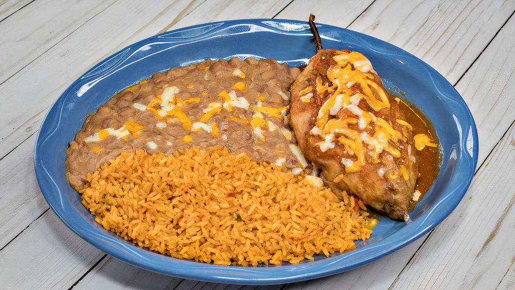 Chile Relleno · Chile relleno (beef, chicken or cheese) with ranchera sauce and cheese on top. Served with two sides.