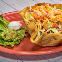 Taco Salad · Filled with chicken or beef, beans, lettuce, tomatoes and cheese, served with guacamole and ...