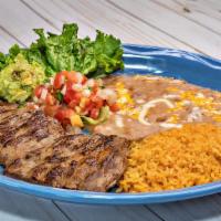 Carne Asada · Tenderized beef steak grilled to perfection served with guacamole, pico de gallo and two sid...