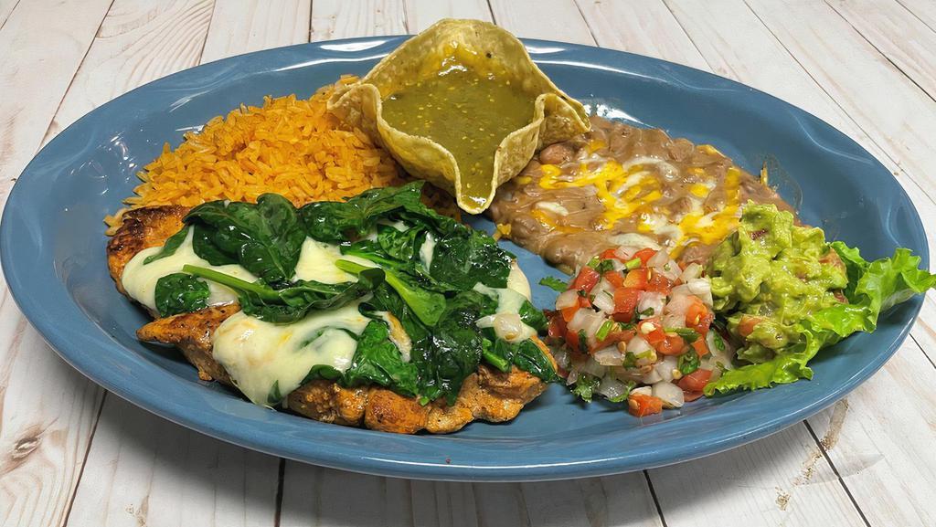 Pollo Verde · Grilled chicken breast with spinach, verde sauce and white melted cheese on top. Served with guacamole, pico de gallo and two sides.