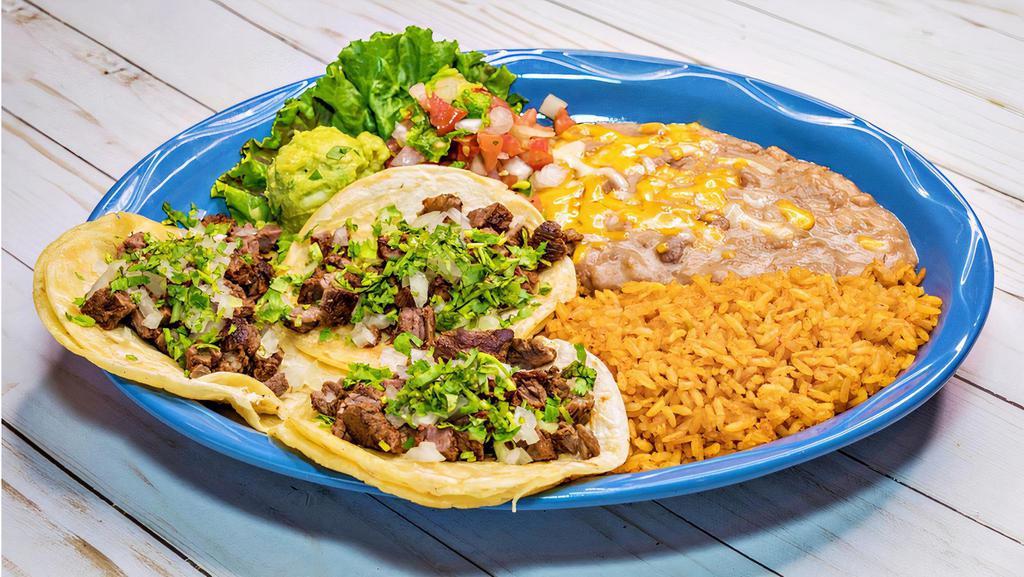 Mexican Tacos · Three soft corn tortilla tacos filled with beef, chicken or pastor fajita with onions, cilantro, pico de gallo and guacamole. Served with two sides.