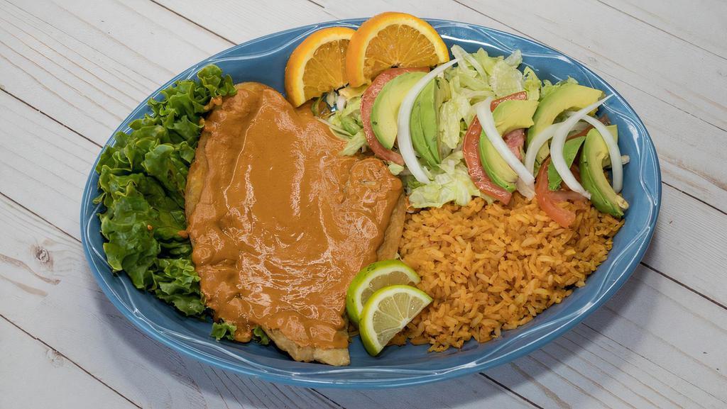 Pescado Al Chipotle · Grilled fish fillet cooked on a special creamy chipotle sauce. Served with rice and salad.