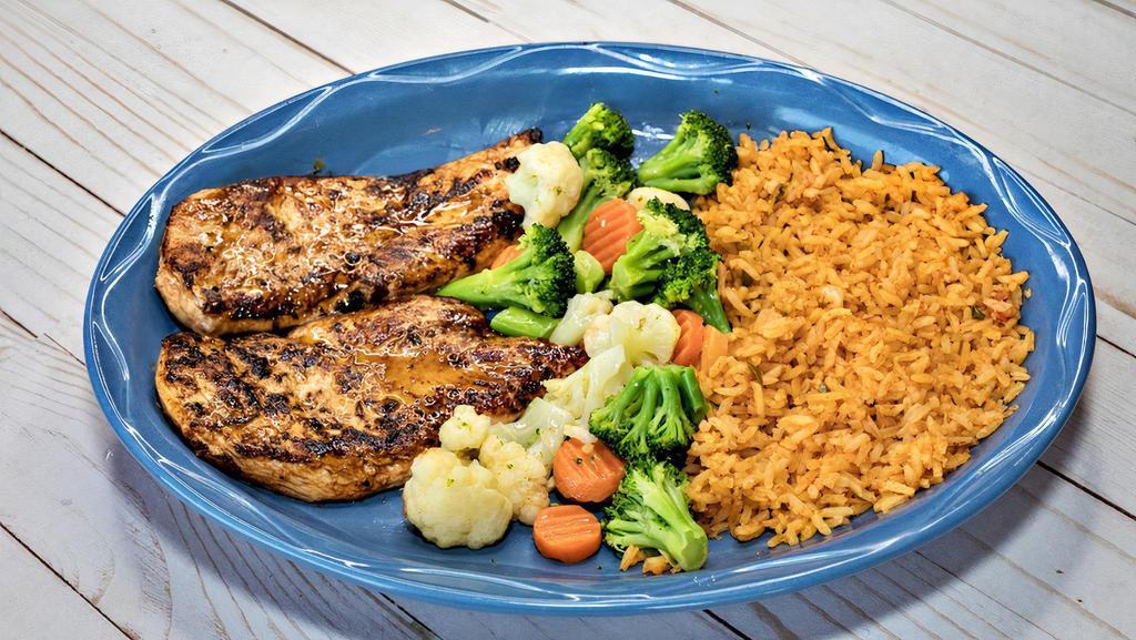 Pollo Chulo · Grilled boneless chicken breast, served with vegetables mix and rice on the side.