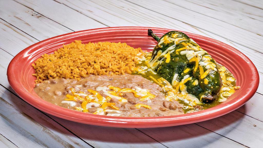 Poblano Relleno · Poblano relleno (beef, chicken or cheese) with verde sauce and cheese on top. Served with two sides.