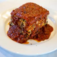 Lasagna · Layers of pasta baked with mozzarella, ricotta and parmigiano cheese in our rich tomato meat...