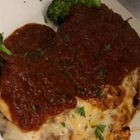 Eggplant Parmigiana · Fresh eggplant slices lightly breaded and topped with our freshly made sauce and melted mozz...