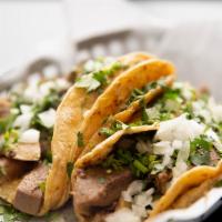 Lengua Taco · Includes cilantro and onions. Served on corn tortilla.