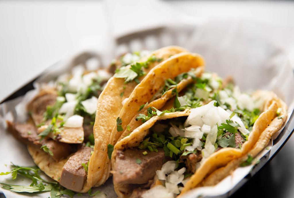 Lengua Taco · Includes cilantro and onions. Served on corn tortilla.