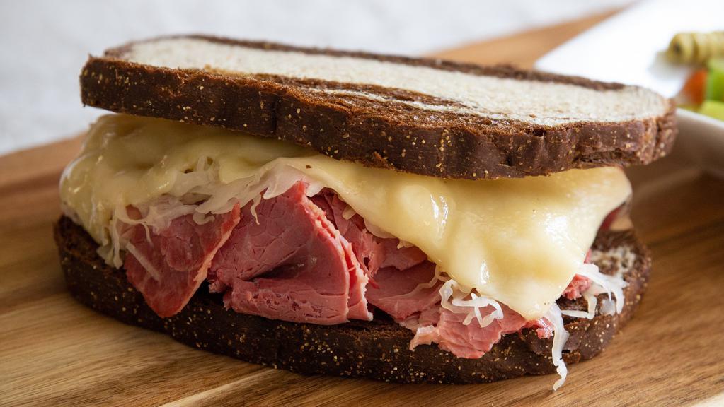 Reuben · Slow cooked corned beef, kraut, swiss and Thousand island on toasted marble rye.