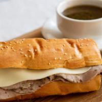 French Dip · House cooked beef dipped in au jus and covered in mozzarella. Au jus for dipping. Served wit...