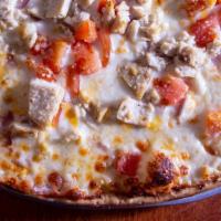 Alfredo Chicken Pizza · Alfredo sauce, chicken, tomato, onion and Parmesan.