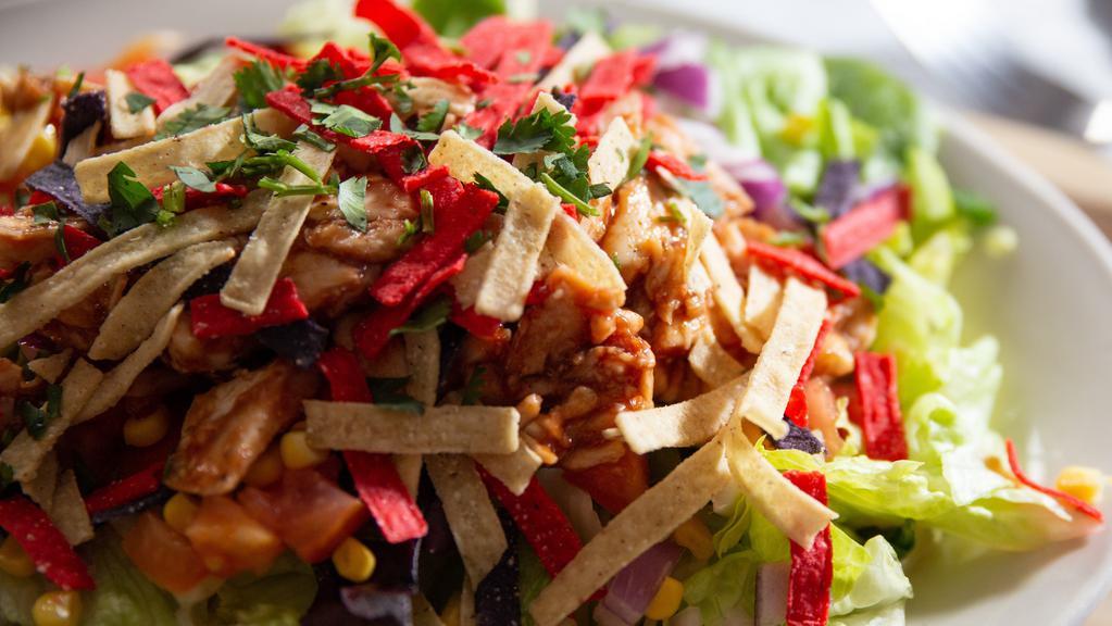 Bbq Chicken Southwest Salad · Chopped chicken tossed in BBQ sauce, cheddar jack cheese, corn, cilantro, tomato, onion and tortilla strips.