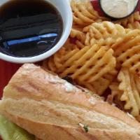 French Dip · Thinly sliced prime rib with a garlic herb spread and onion straws served with a side of au ...