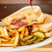 Reuben (Deluxe) · With french fries and coleslaw. Corned beef, sauerkraut, swiss cheese on grilled rye.