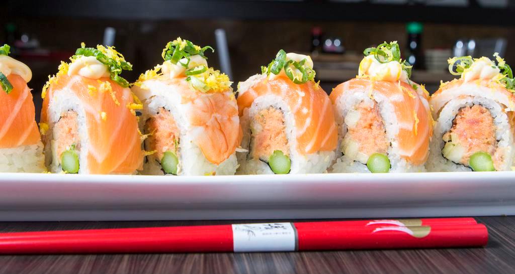 Sakura Roll · Spicy tuna, asparagus, cucumber topped w/ salmon, steamed shrimp, Japanese mayo, green onion and lemon zest.