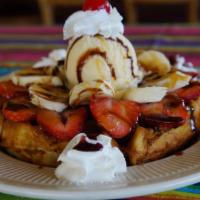 Banana Split Waffle · One big scoop of vanilla ice cream topped with strawberries, pineapple, bananas, chocolate s...