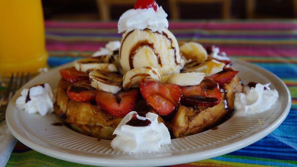 Banana Split Waffle · One big scoop of vanilla ice cream topped with strawberries, pineapple, bananas, chocolate syrup, pecans and whipped cream