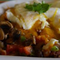 Huevos Rancheros · Topped with mild red sauce