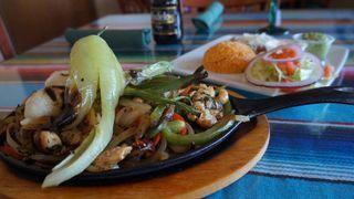 Chicken Fajitas · Made with fresh green and red peppers, onions, chile toriado, and cebolitas with rice, beans...