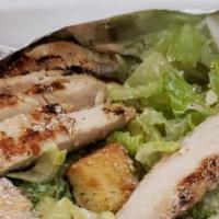 Caesar Salad · Crisp romaine tossed with creamy Caesar dressing topped with Parmesan cheese, and toasted cr...