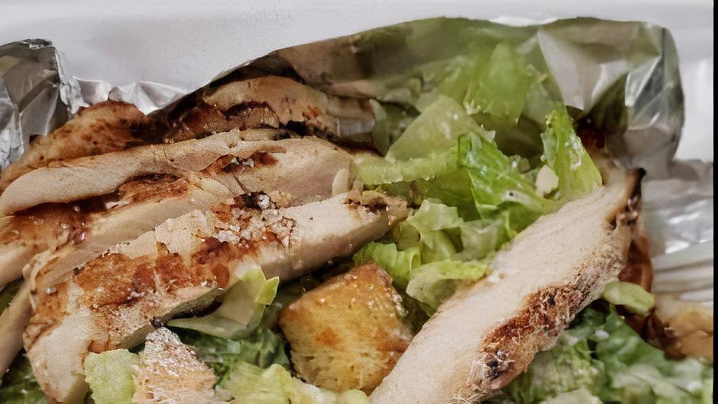Caesar Salad · Crisp romaine tossed with creamy Caesar dressing topped with Parmesan cheese, and toasted croutons.