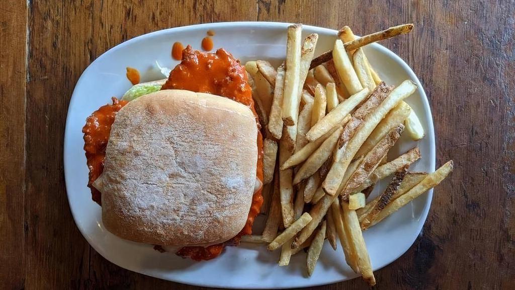 Buffalo Chicken Swiss · Hand breaded fried chicken breast tossed in buffalo sauce and topped with Swiss cheese, lettuce and tomato.