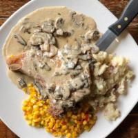 Iowa Chop · 10 oz. pan seared pork chop topped with whiskey gravy and mushrooms. Served with Yukon Gold ...