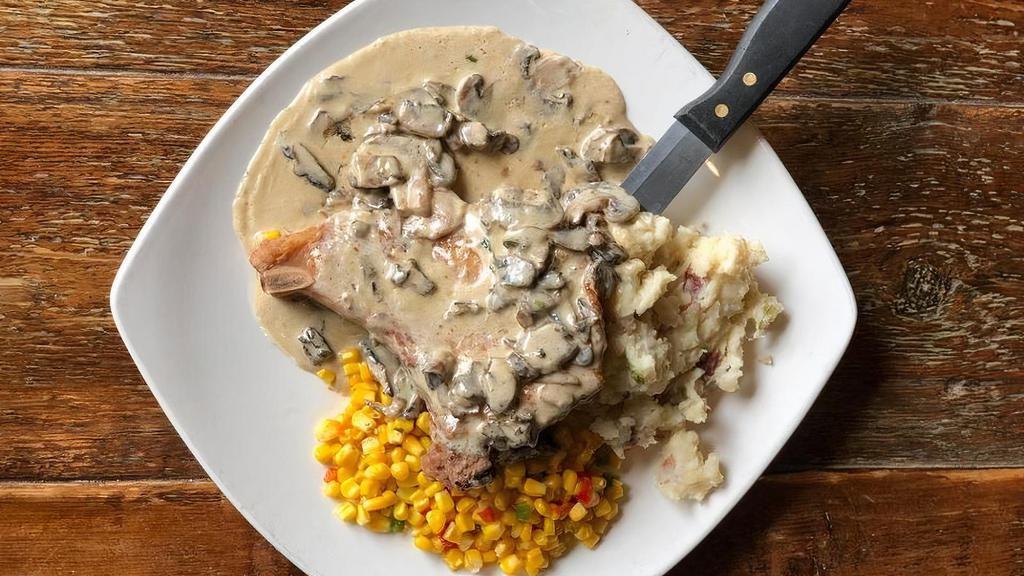 Iowa Chop · 10 oz. pan seared pork chop topped with whiskey gravy and mushrooms. Served with Yukon Gold smashed potatoes and sautéed corn and peppers.