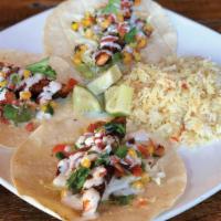 Blackened Salmon Tacos · Blackened salmon, grilled corn tortillas, shredded cabbage, lime corn salsa, topped with hor...