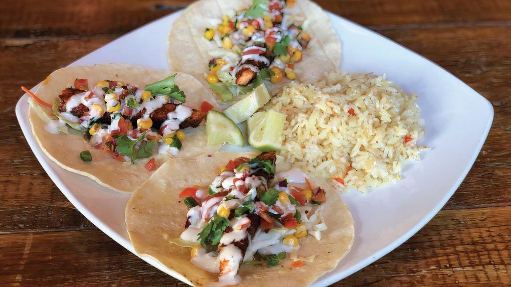 Blackened Salmon Tacos · Blackened salmon, grilled corn tortillas, shredded cabbage, lime corn salsa, topped with horseradish cream sauce. Served with lemon rice.