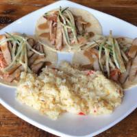 Bulgogi Tacos · Three corn tortillas filled with a kimchi-style slaw, marinated pork, cucumber sunomono and ...