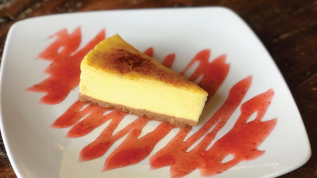 Crème Brûlée Cheesecake · A perfect blend of two classic desserts served with our house made Strawberry Sauce.