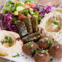 Vegetarian Plate · Hummus, falafel, grape leaves, Baba ghanouj, and house salad served with pita bread.