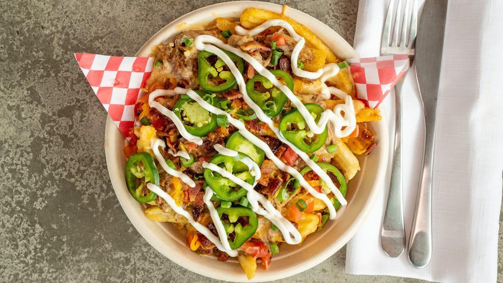 Hog Fries · Fries topped with carnitas, bacon, jalapenos, beer cheese sauce & pico de gallo